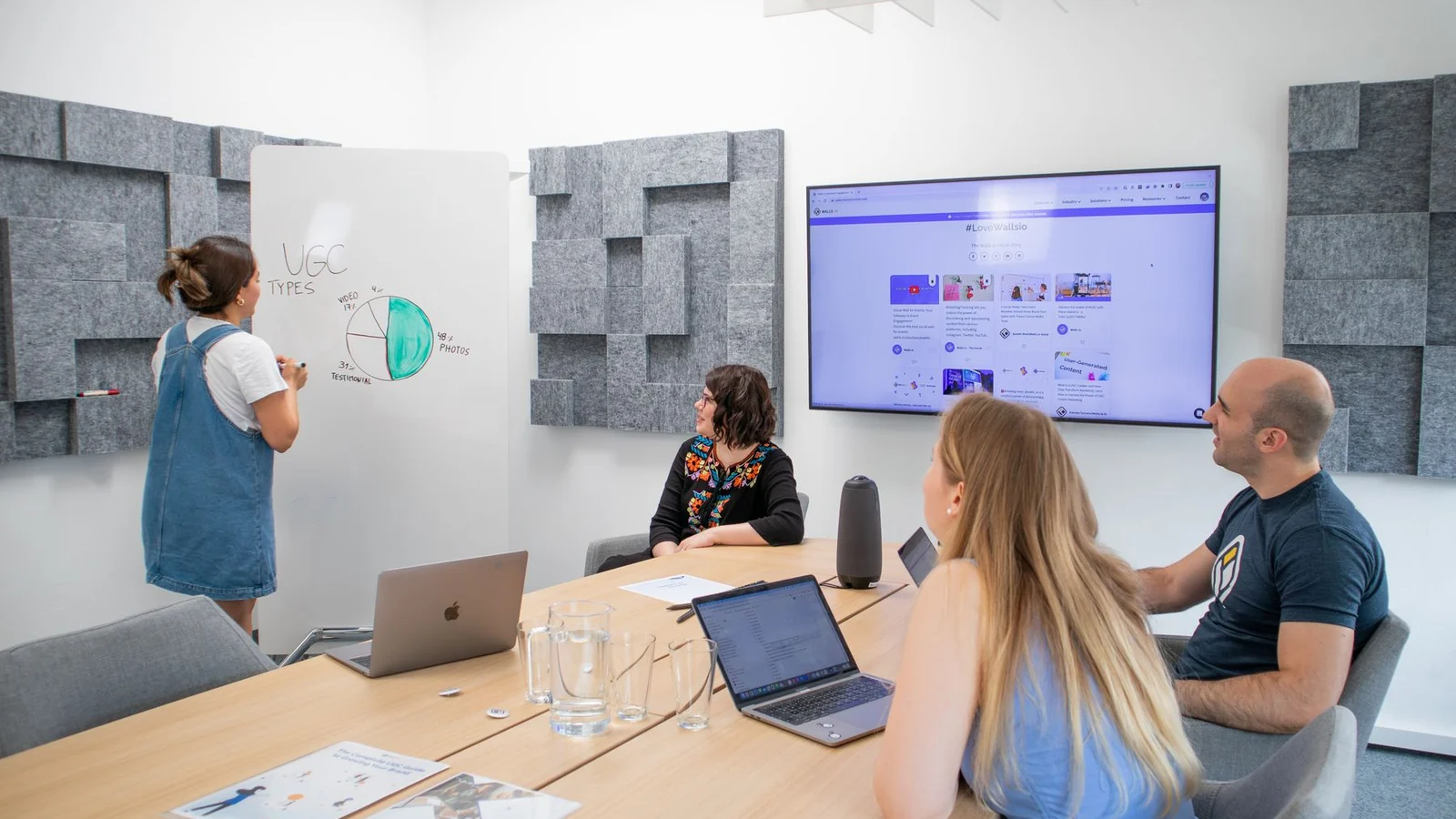 Marketing team coordinating strategy around a presentation