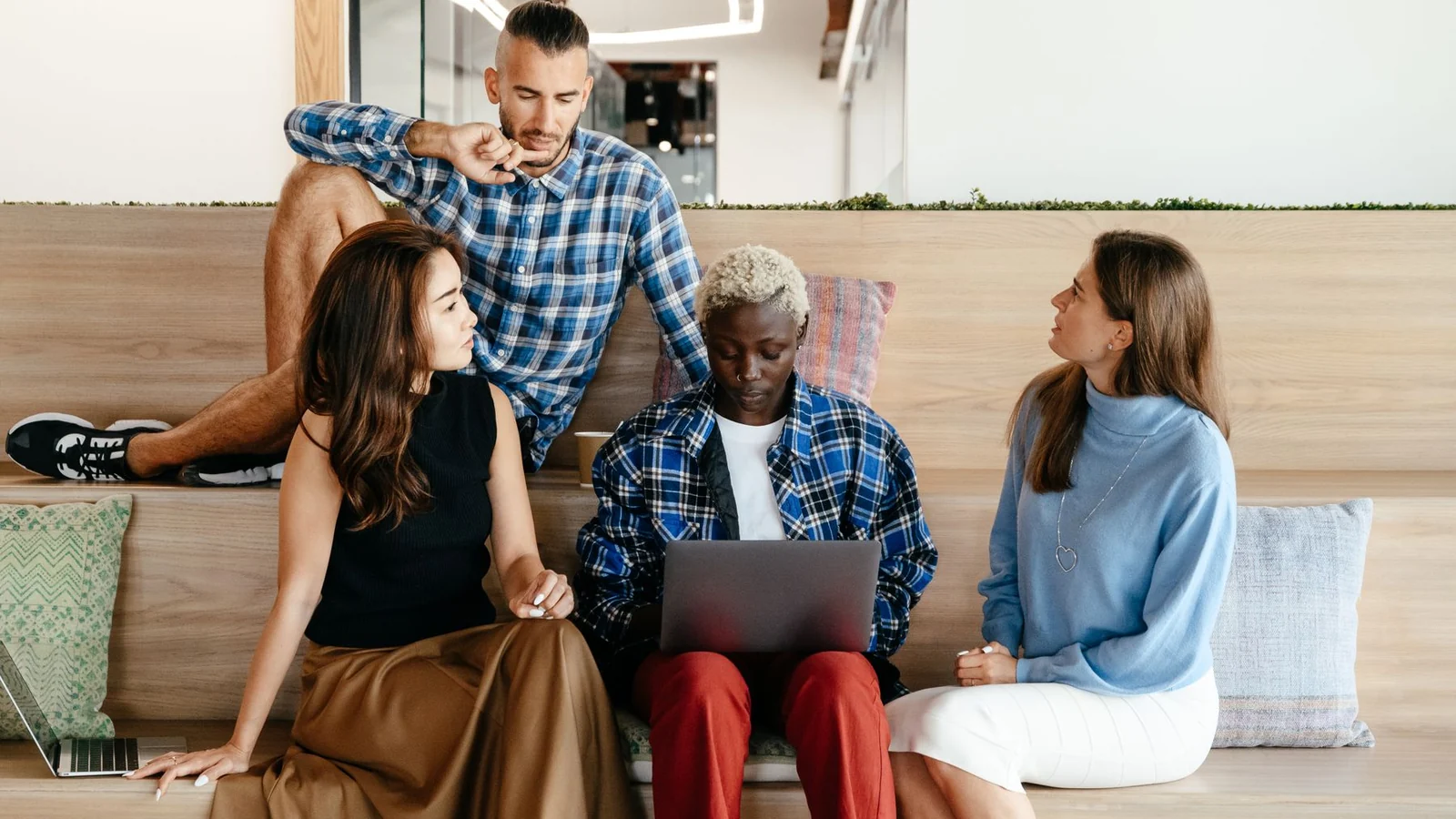Business colleagues coordinating campaign work on a laptop