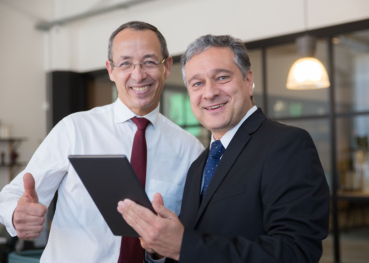 Business leaders reviewing campaign results on a tablet